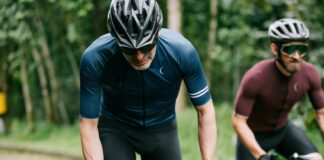 man in blue long sleeve shirt and black shorts riding black bicycle