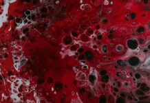 a red and black painting with lots of bubbles