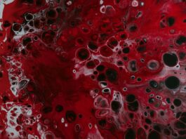 a red and black painting with lots of bubbles