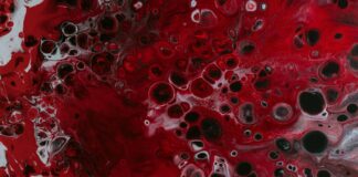 a red and black painting with lots of bubbles