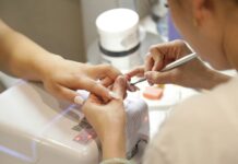 a woman getting her nails done at a nail salon